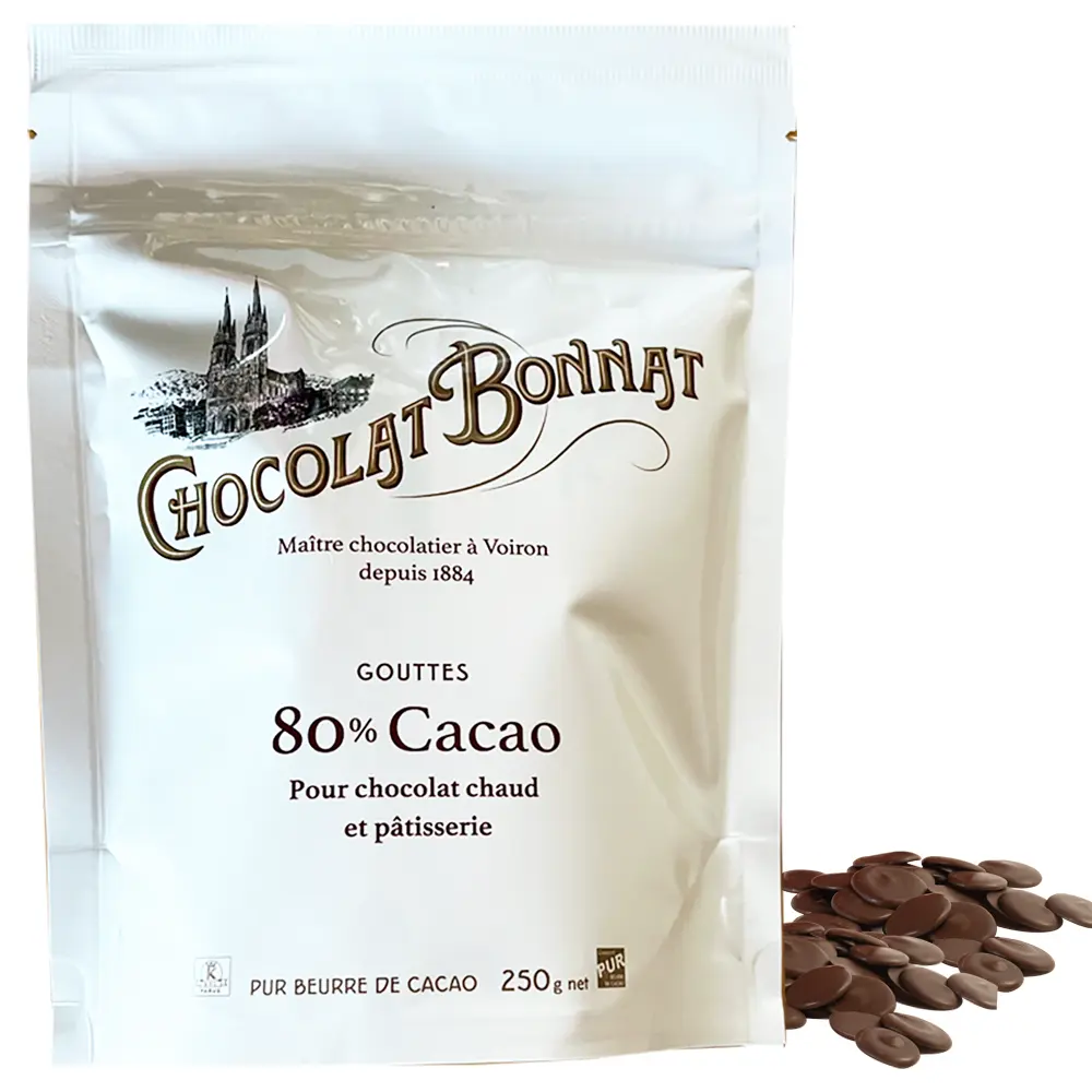 BONNAT | Trinkschokolade Schokoladendrops »Cacao« 80% | 250g Schokoladendrops mit 80% Kakaoantel von Bonnat Frankreich , weiße Verpackung neben Schokoladendrops B